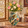 Persian floral twist ceramic vase with pink tulips, white ranunculus and eucalyptus beside a Moroccan lattice window